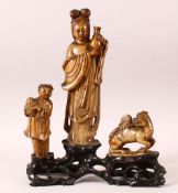 A GOOD 18TH / 19TH CENTURY CHINESE SOAPSTONE GROUP, the central female figure holding an urn, a