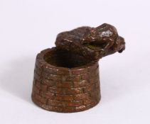 A JAPANESE BRONZE FIGURE OF A TOAD OVER A WELL, with carved calligraphy to the toad base, the