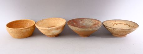 A GROUP OF FOUR EARLY CHINESE EARTHENWARE CIRCULAR BOWLS, various sizes.