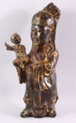 A CHINESE CAST BRONZE FIGURE OF A BEARDED SAGE, holding a small boy in his arms, with traces of