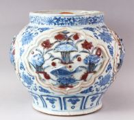 A YUAN LARGE BLUE AND WHITE JAR, the body with four incised panels depicting carp swimming amongst