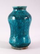 A 19TH CENTURY ISLAMIC MARKET DRUG JAR, with turquoise glazed decoration, 20cm high.