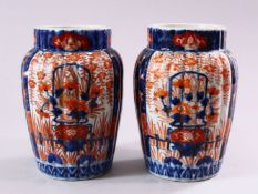 A PAIR OF JAPANESE MEIJI PERIOD IMARI PORCELAIN VASES, with ribbed body, and panel decoration of