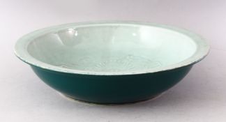 A 20TH CENTURY CHINESE CELEDON CIRCULAR DISH, the centre with moulded dragon decoration, green