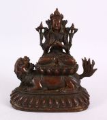 A TIBETAN BRONZE FIGURE OF BUDDHA / DEITY, in a seated position upon a recumbent lion dog, upon a