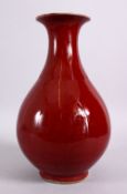A CHINESE OX BLOOD RED YUHUCHUNPIN PORCELAIN VASE, with a ox blood red ground and a flared rim,