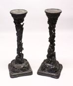 A PAIR OF 19TH CENTURY CARVED WOODEN DRAGON STANDS, the centres carved with intertwined dragons down