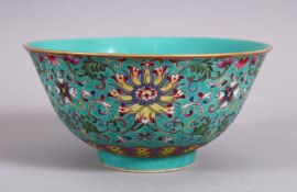 A CHINESE FAMMILE ROSE TURQUOISE GROUND LOTUS PORCELAIN BOWL, decorated with formal scrolling