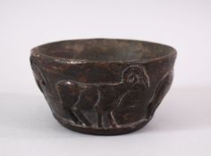 AN EARLY SUMERIAN POTTERY RAM BOWL, with relief carved rams, 13cm