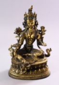 A TIBETAN GILT BRONZE FIGURE OF A SEATED FEMALE DIETY, on lotus pad, 24cm high.