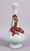 A CHINESE COPPER RED GARLIC HEAD PORCELAIN CHILONG VASE, the monochrome body with iron red moulded
