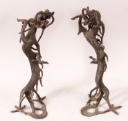 A PAIR OF CHINESE CAST BRONZE DRAGONS, standing on their hind legs, 35cm high.