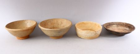 A GROUP OF FOUR EARLY CHINESE EARTHENWARE CIRCULAR BOWLS, various sizes.