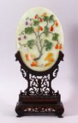 A GOOD SMALL CHINESE JADE TABLE SCREEN, the oval panel onlaid with various hardstones depicting a