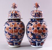 A PAIR OF JAPANESE MEIJI PERIOD IMARI PORCELAIN VASES AND COVERS, with ribbed body's, and panels