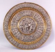 A LATE 19TH CENTURY INDIAN TANJORE SILVER AND COPPER EMBOSSED BRASS TRAY/PLAQUE, decorated with