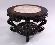 A GOOD CHINESE CARVED HARDWOOD STAND, with inlaid marble top, 22cm high, 30cm diameter.