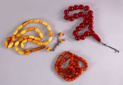 A COLLECTION OF TWO ISLAMIC POSSIBLY OTTOMAN AMBER PRAYER BEADS AND ANOTHER POSSIBLY CHERRY AMBER