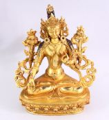 A TIBETAN GILT BRONZE SEATED FEMALE DIETY, 20cm high.