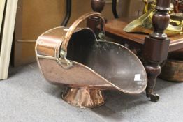 A copper coal scuttle.