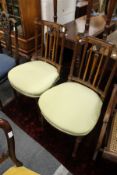 A good pair of Edwardian mahogany and satinwood inlaid bedroom chairs.