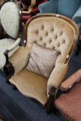 A good Victorian mahogany framed button back armchair with carved decoration.