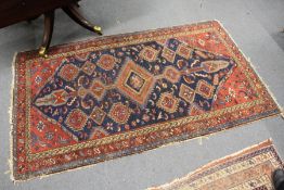 A Persian rug, blue ground with geometric decoration.