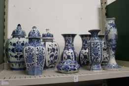 A quantity of Dutch Delft blue and white jars and covers, vases etc.