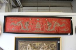 A Chinese metal thread embroidered picture depicting two dragons chasing the pearl of wisdom,