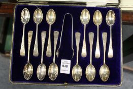 A cased set of twelve bright cut silver coffee spoons with sugar nips, London 1884.