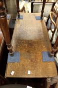 An oak rectangular drop leaf gate leg dining table on turned legs with pad feet.