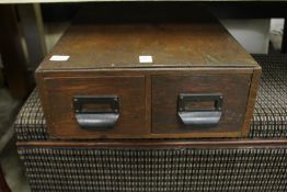 A two drawer card index box.