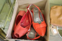 Two pairs of ladies' red shoes.