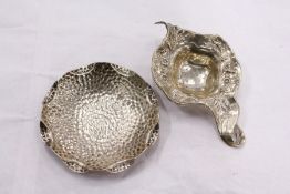 A sterling silver tea strainer and a hammered Irish dish.