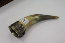 A white metal mounted horn drinking vessel.