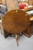 A George III mahogany circular tilt top tripod table.