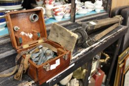 A boxed surveying instrument with tripod.