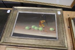 A still life of wine glass and grapes, oil on board, in a gilt frame.
