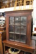 A mahogany corner cabinet.
