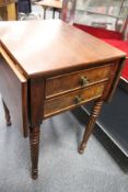 A 19th century mahogany two drawer drop leaf work table (lacking basket).
