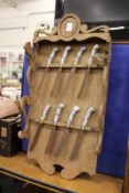 An unusual oak rack holding eight Delft porcelain handled knives.