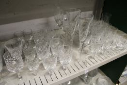 A shelf of cut glass drinking glasses.