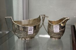 A Victorian silver half fluted sugar basin and milk jug, London 1893, 13ozs.