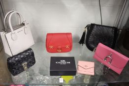 A Coach ladies' pink leather purse with original box and other handbags and purses by Michael Kors