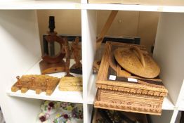 A carved wood and inlaid folding travelling chess board and other wooden items.