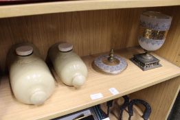 Two old stone hot water bottles and an ornate glass and metal mounted vase and cover.