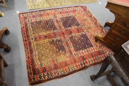A Turkoman rug, red ground with four panels.