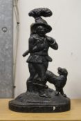 A cast iron door stop modelled as a hunter and dog.