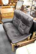 A good Stressless beech framed black leather upholstered high back reclining two seater settee.