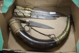 A powder horn and four knives.